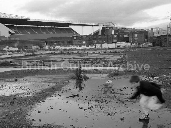 Boy running in the shadow of Celtic Park Print - Tony Davis
